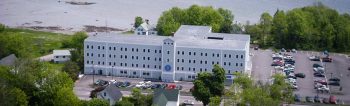 Aerial view of the UMA Rockland Center located inside the Breakwater Building on the coast of Rockland, Maine